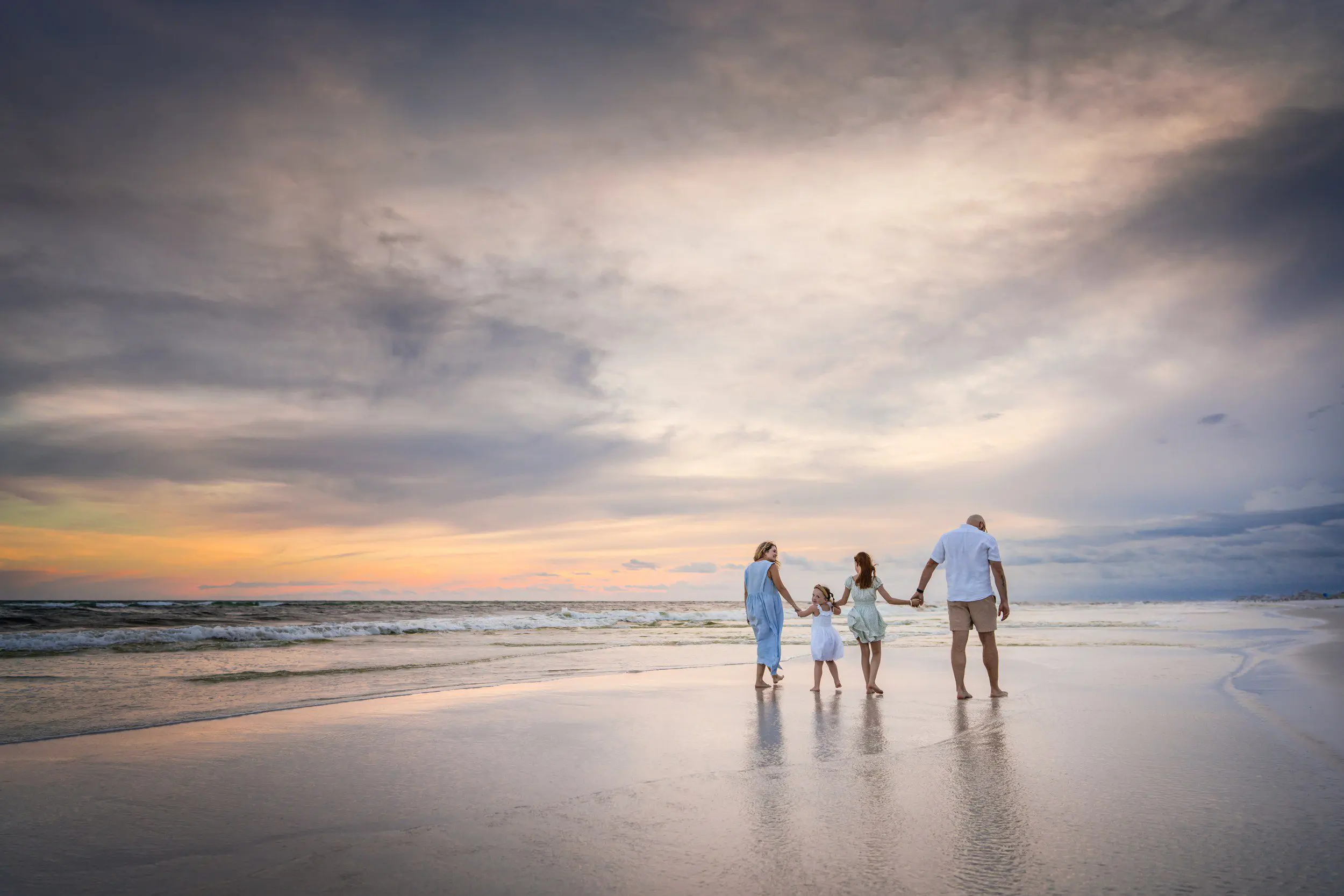Family enjoying an Emerald Coast beach at sunset