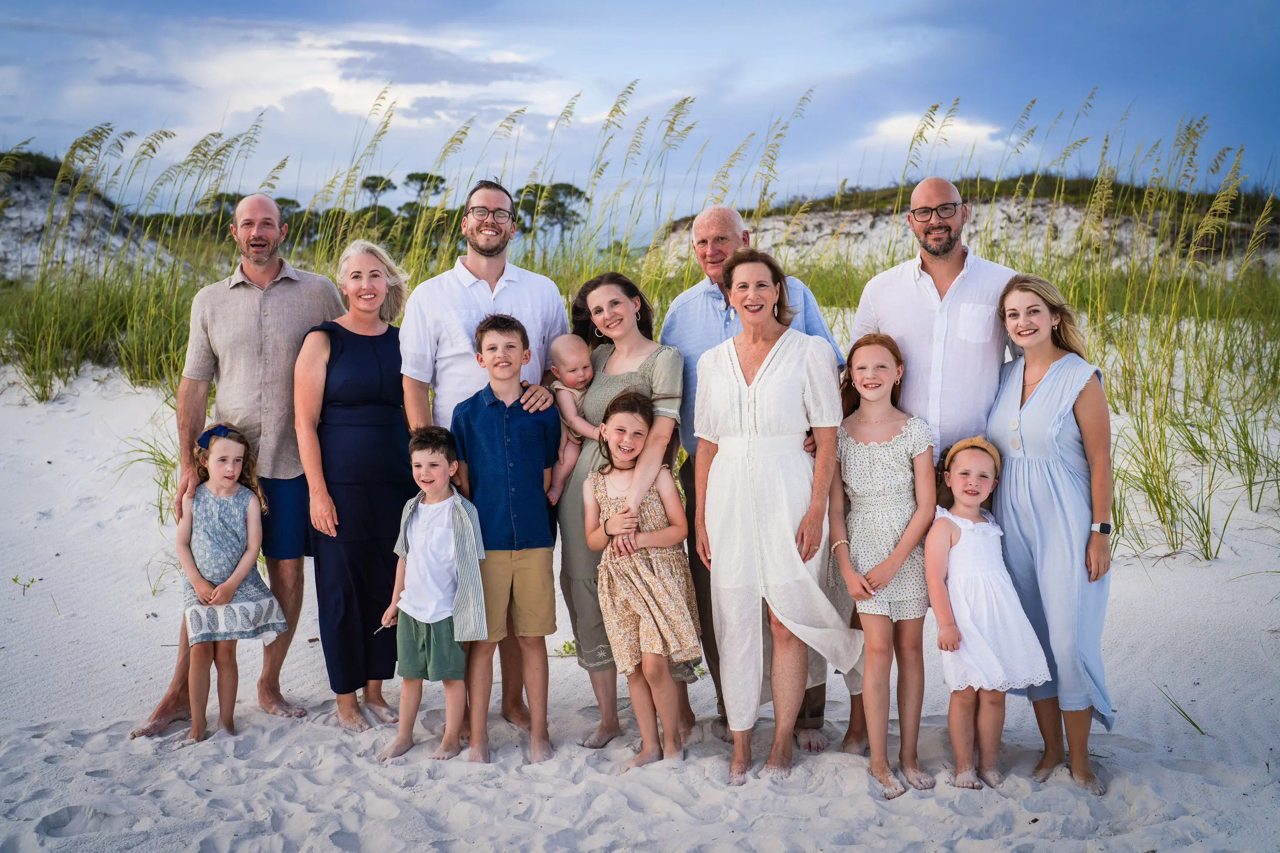 Large multigenerational family posing together on the beach
