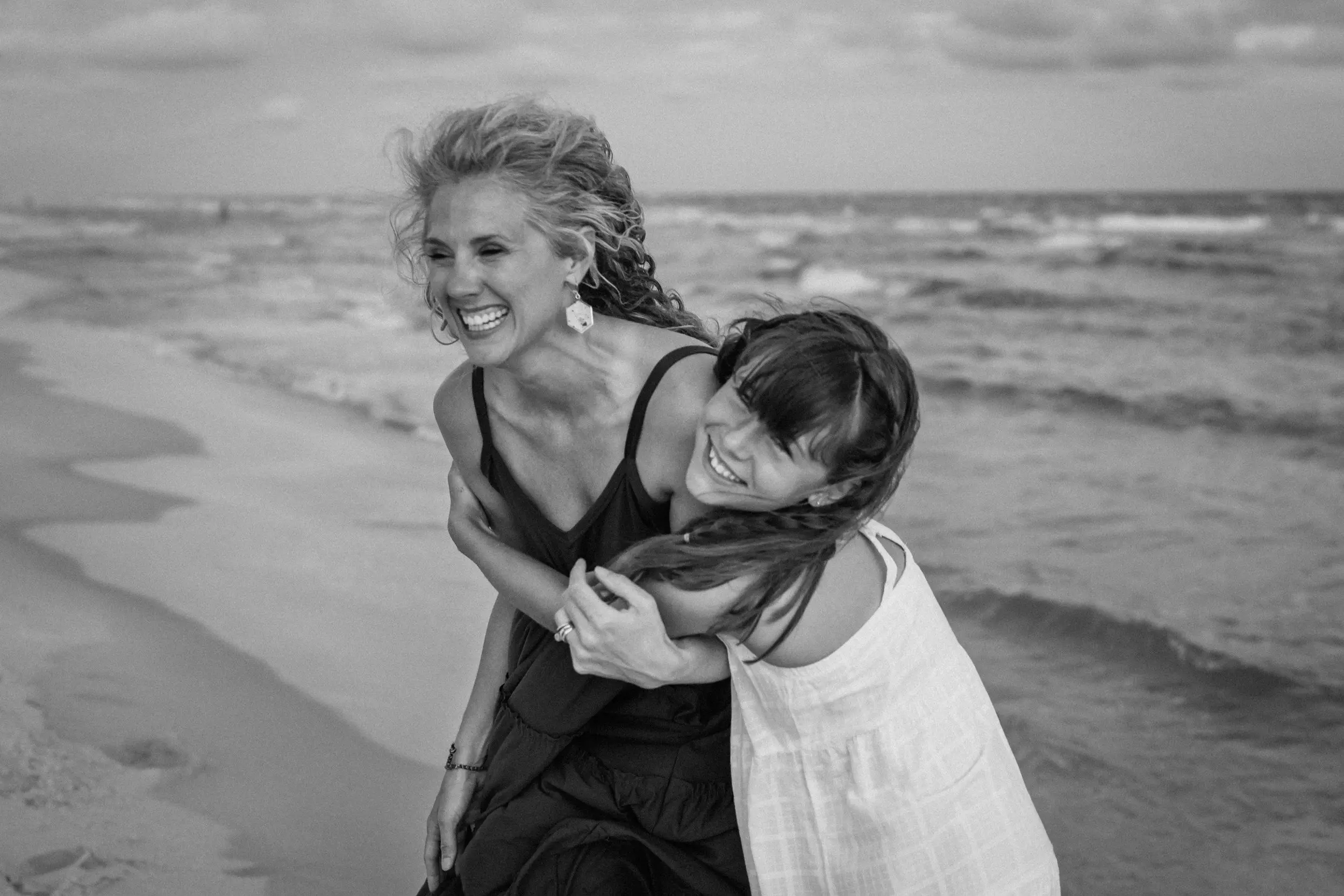 Family sharing a quiet moment together during a beach photography session