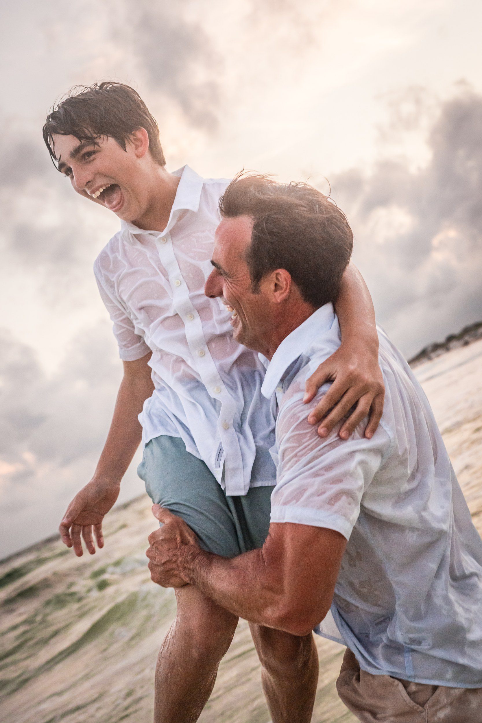 Father and son sharing a natural moment during a beach family session