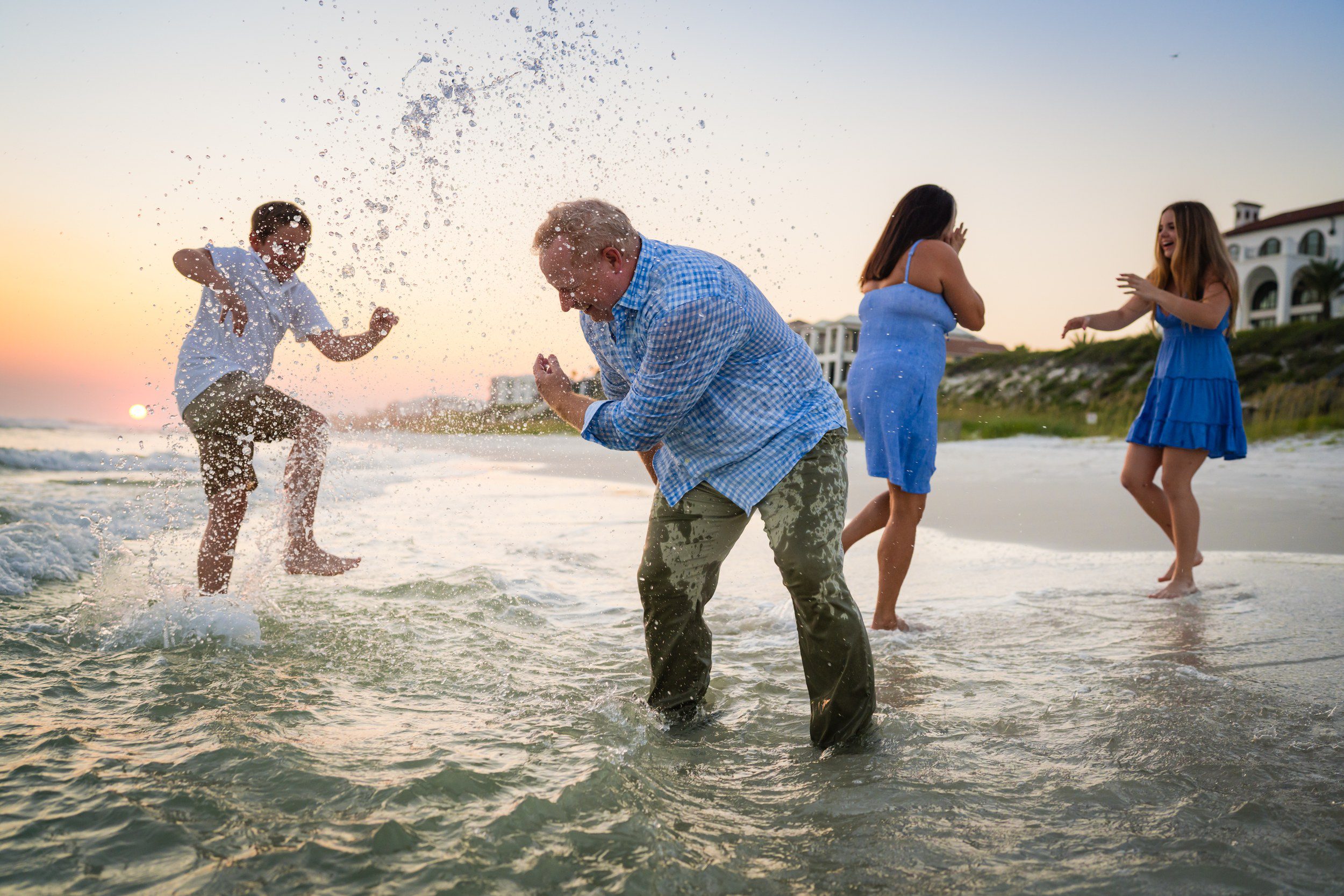 Grandfather playing with grandchildren during a relaxed beach family session