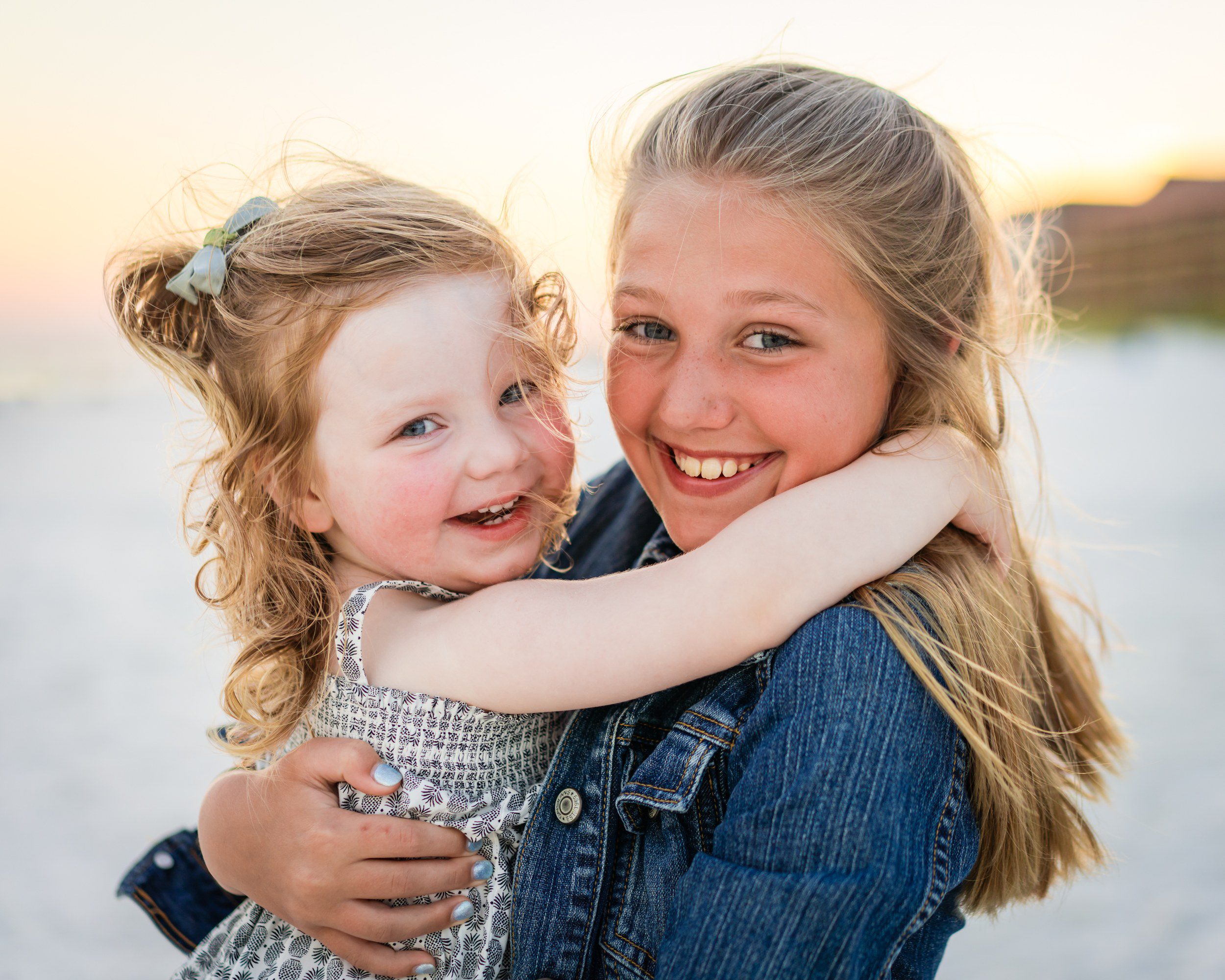 Siblings sharing a natural moment together on the beach